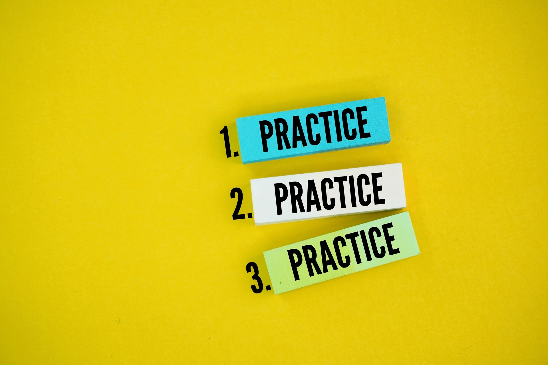 colored paper with three repetitions of the words practice, practice and practice. consistent concept